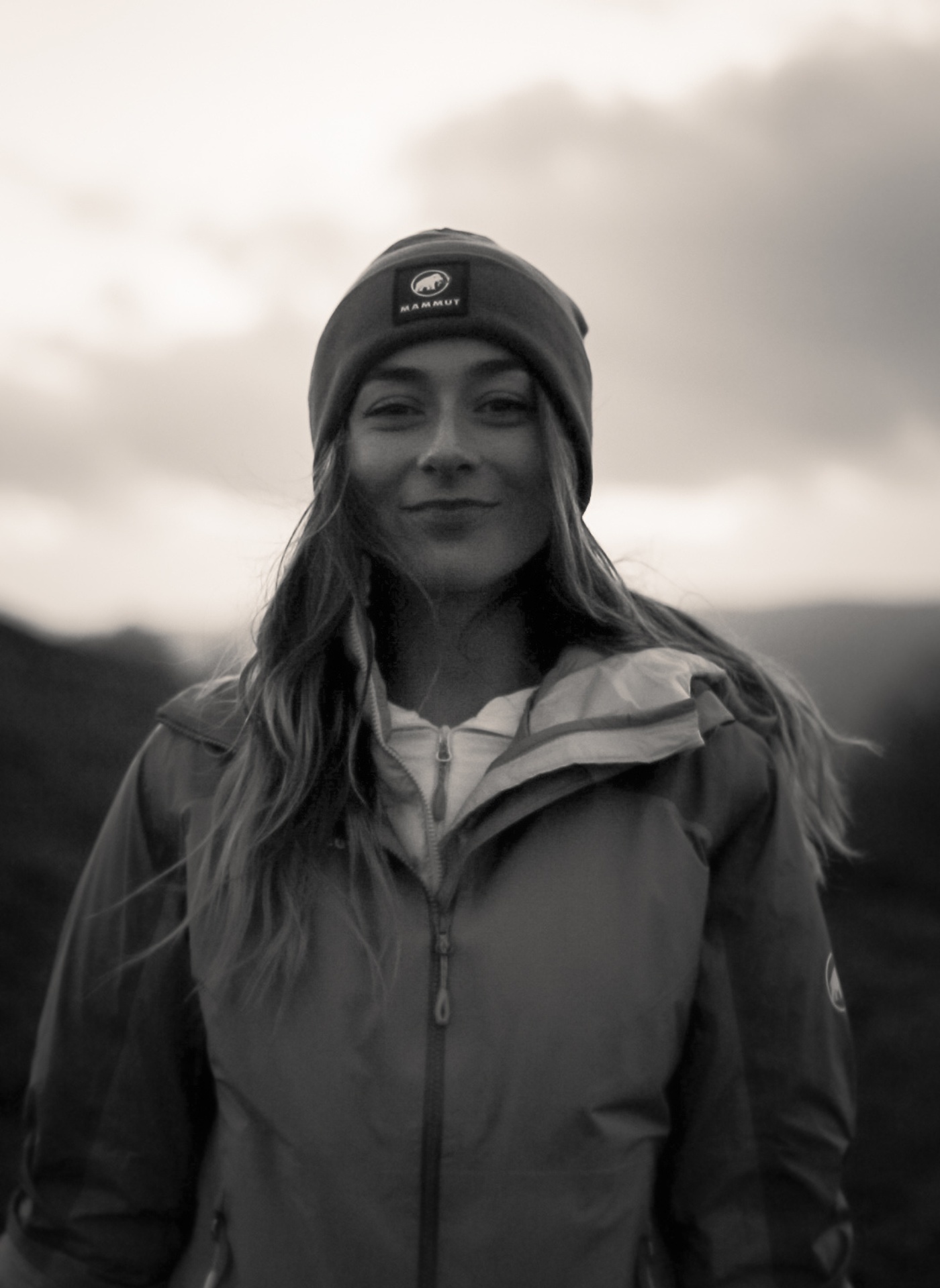 Black and white image of Kate Amanda stood outside wearing Mammut gear