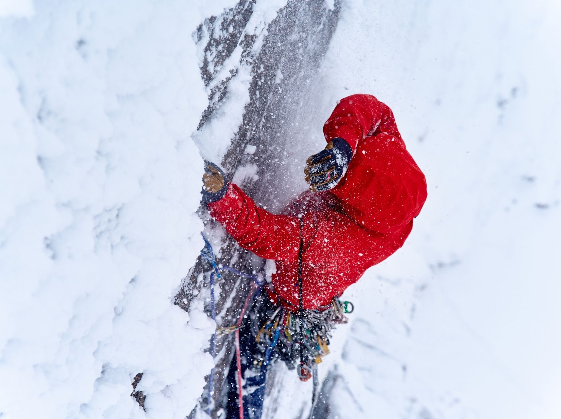 Ice climbing in red Gore Tex jacket.